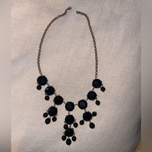 Black bubble necklace with gold chain.